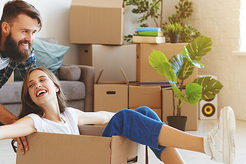 happy young married couple moves to new apartment